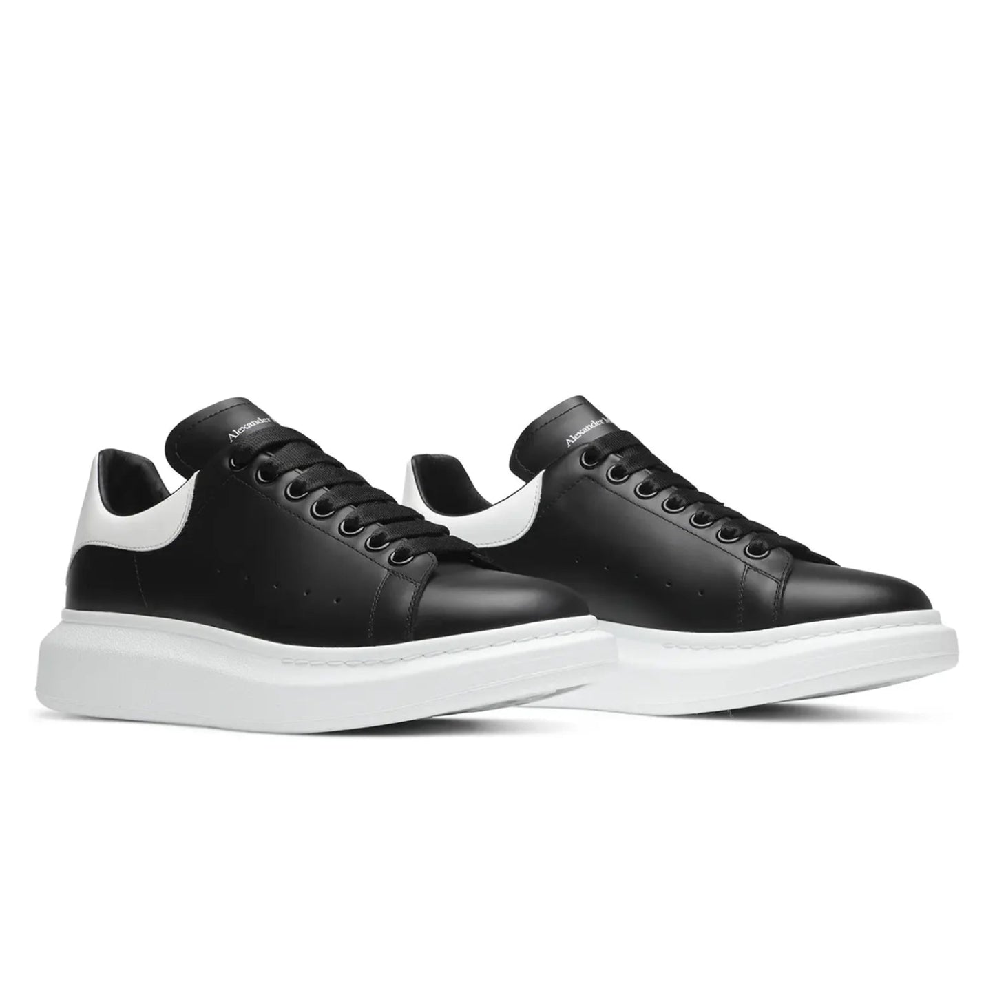 Black sneakers with white soles on a white background