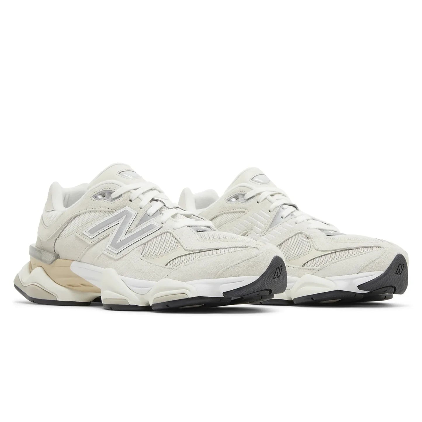 Pair of beige sneakers with New Balance logo on a white background