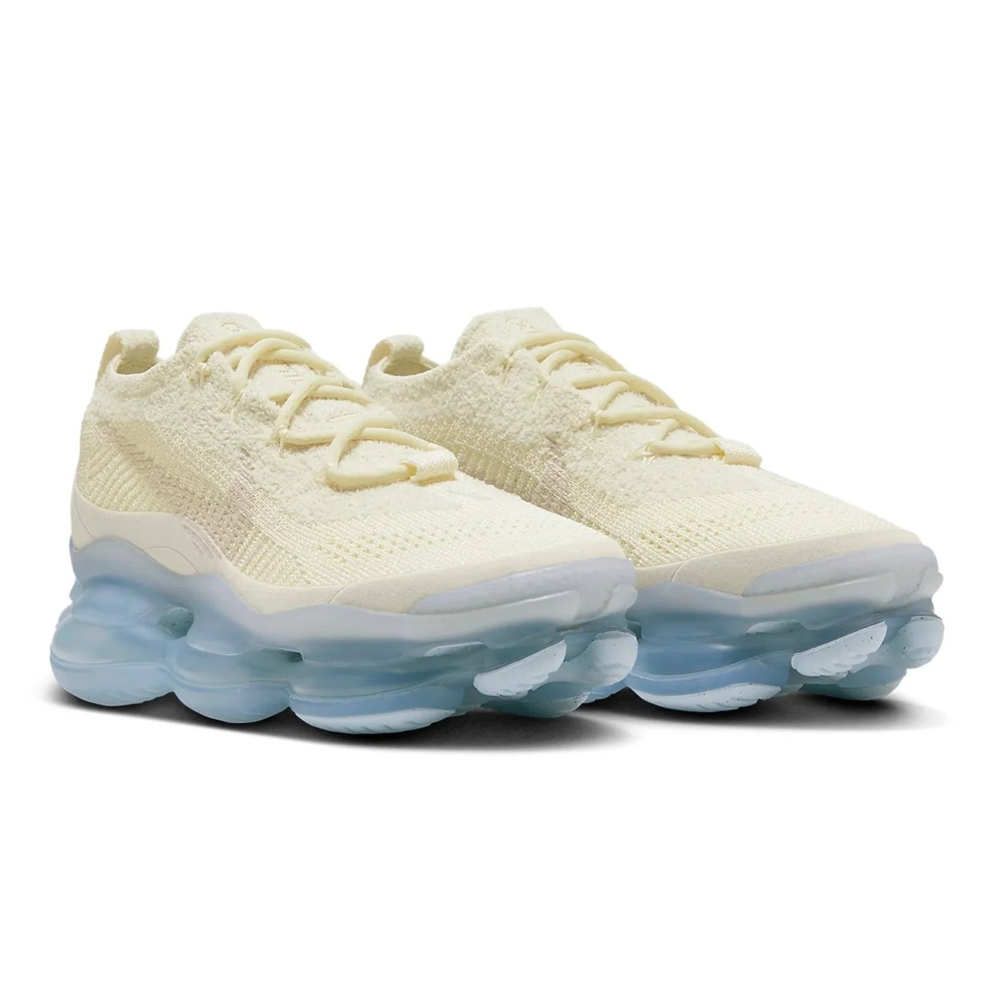 Pair of cream-colored sneakers with a translucent sole on a white background