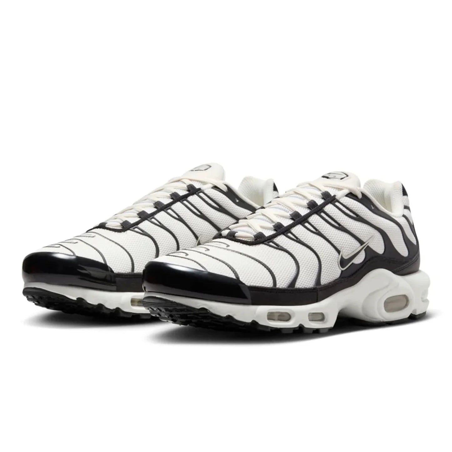 White and black Nike sneakers with zebra pattern on a white background