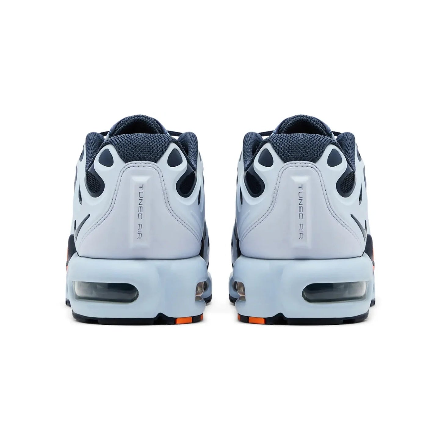 Pair of white sneakers with black and orange accents on a white background