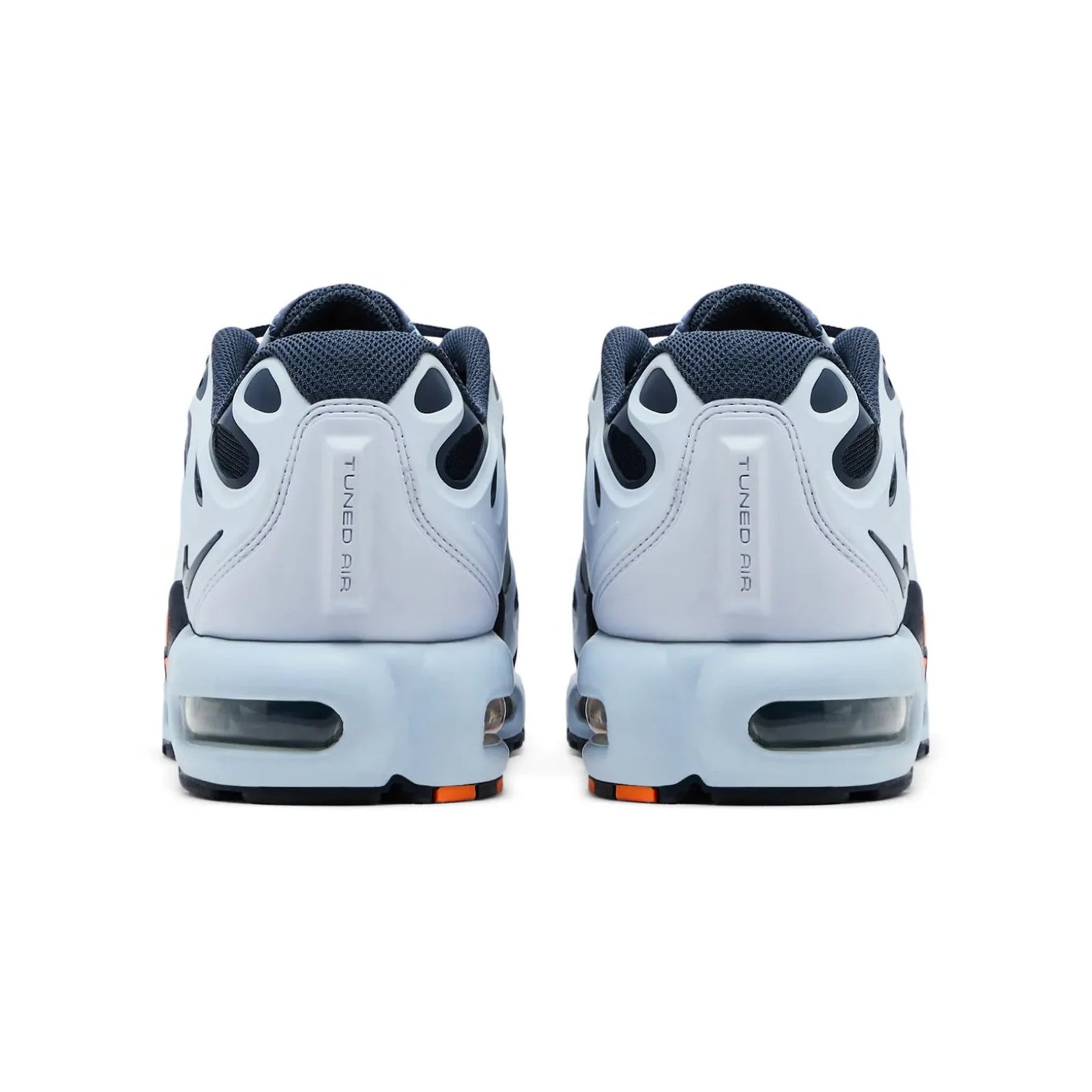 Pair of white sneakers with black and orange accents on a white background