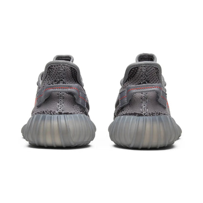 Gray sneakers with a textured sole on a white background