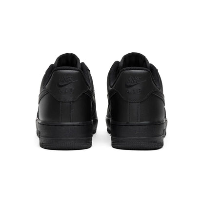 Black Nike sneakers shown from the back on a white background