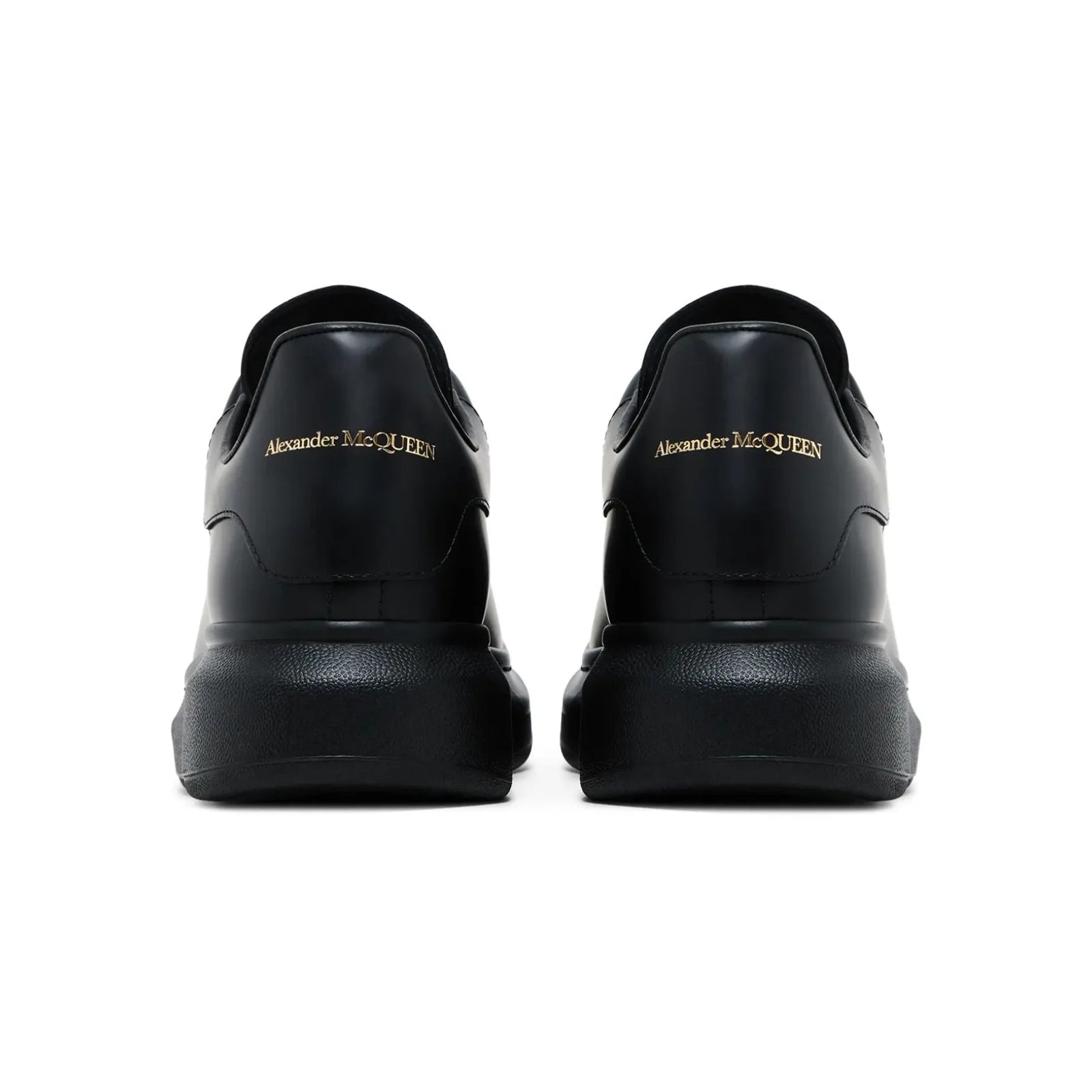 Black sneakers with 'Alexander McQueen' branding on a white background