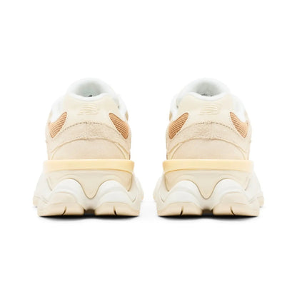 Pair of beige sneakers with a white sole on a white background