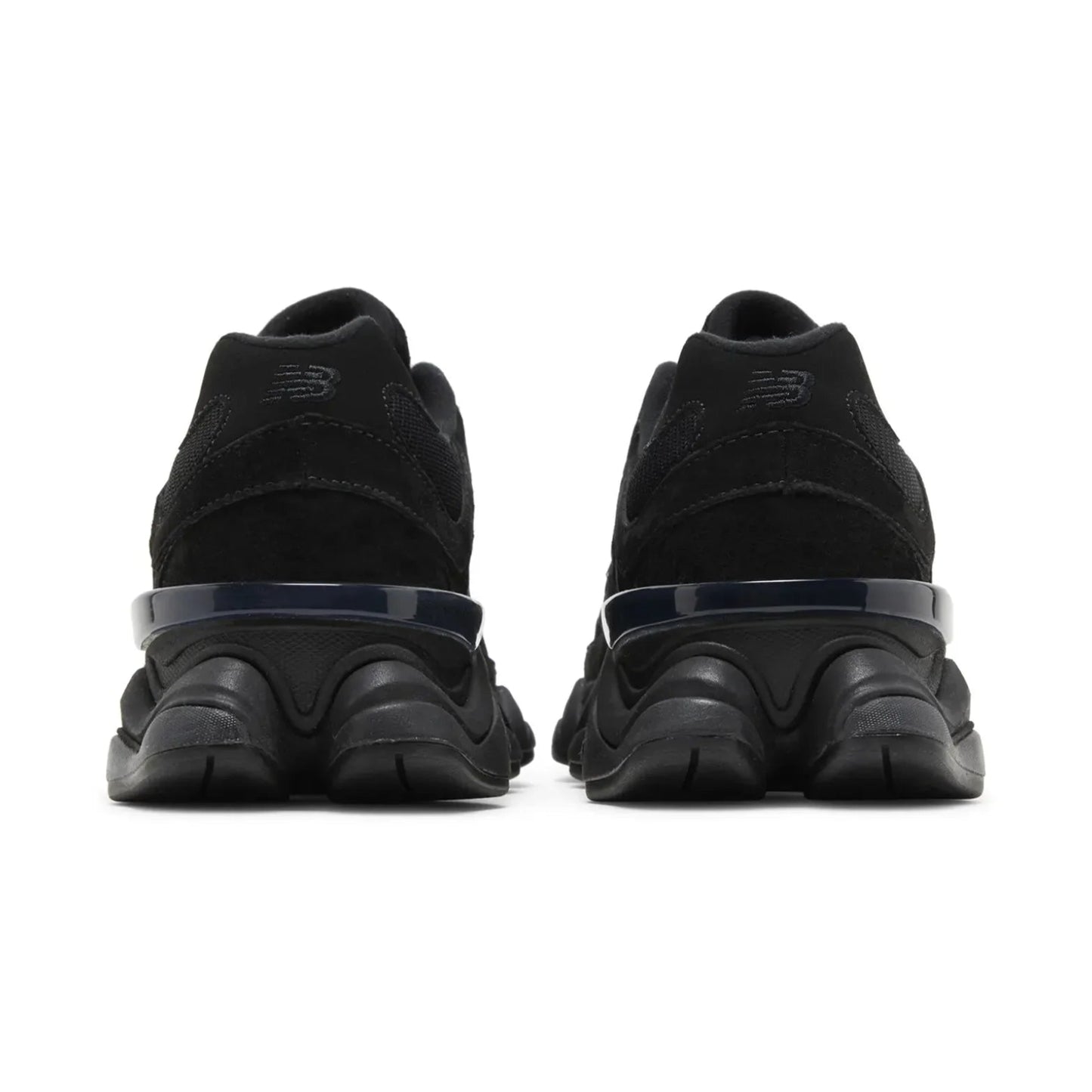 Black sneakers with a focus on sole design on a white background