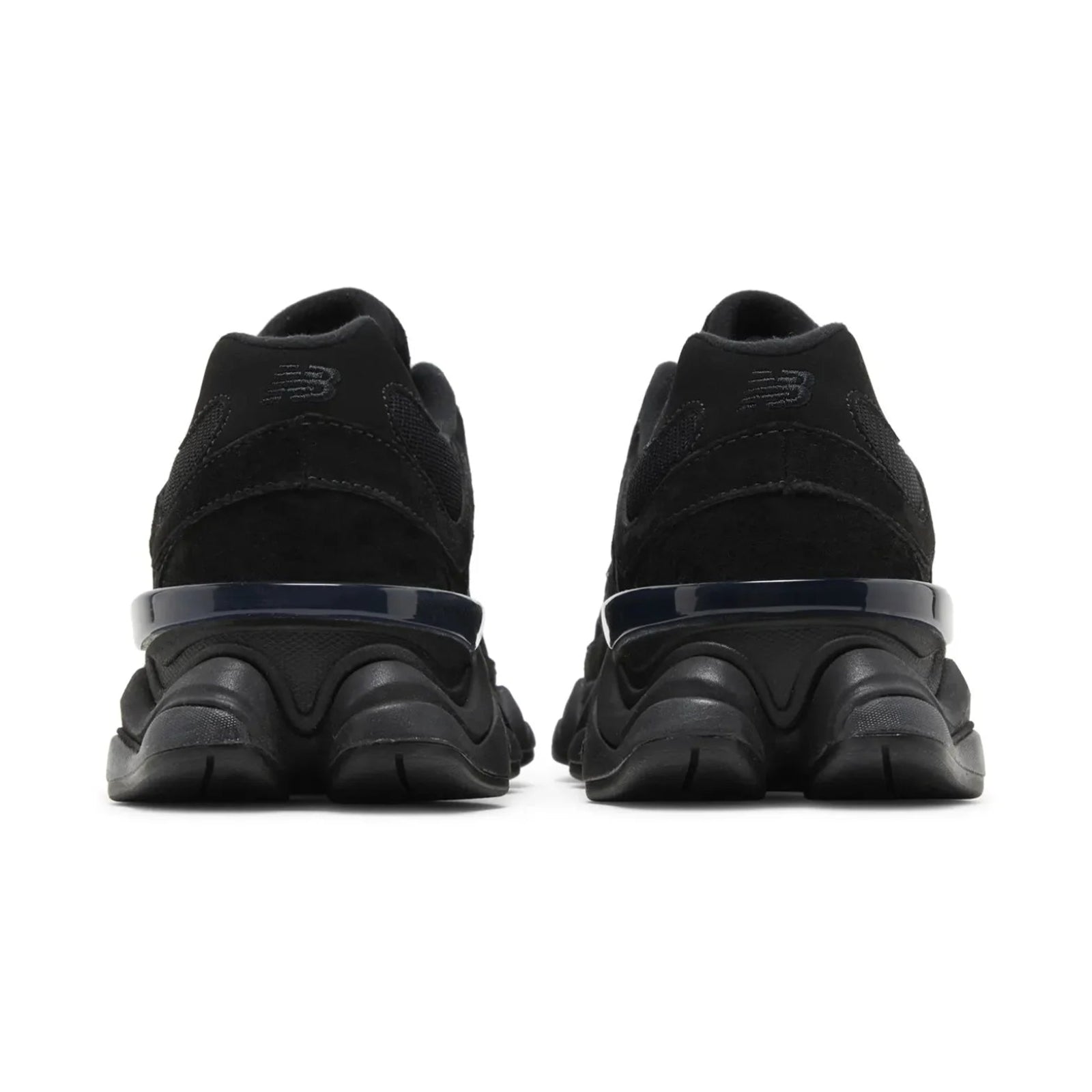 Black sneakers with a focus on sole design on a white background