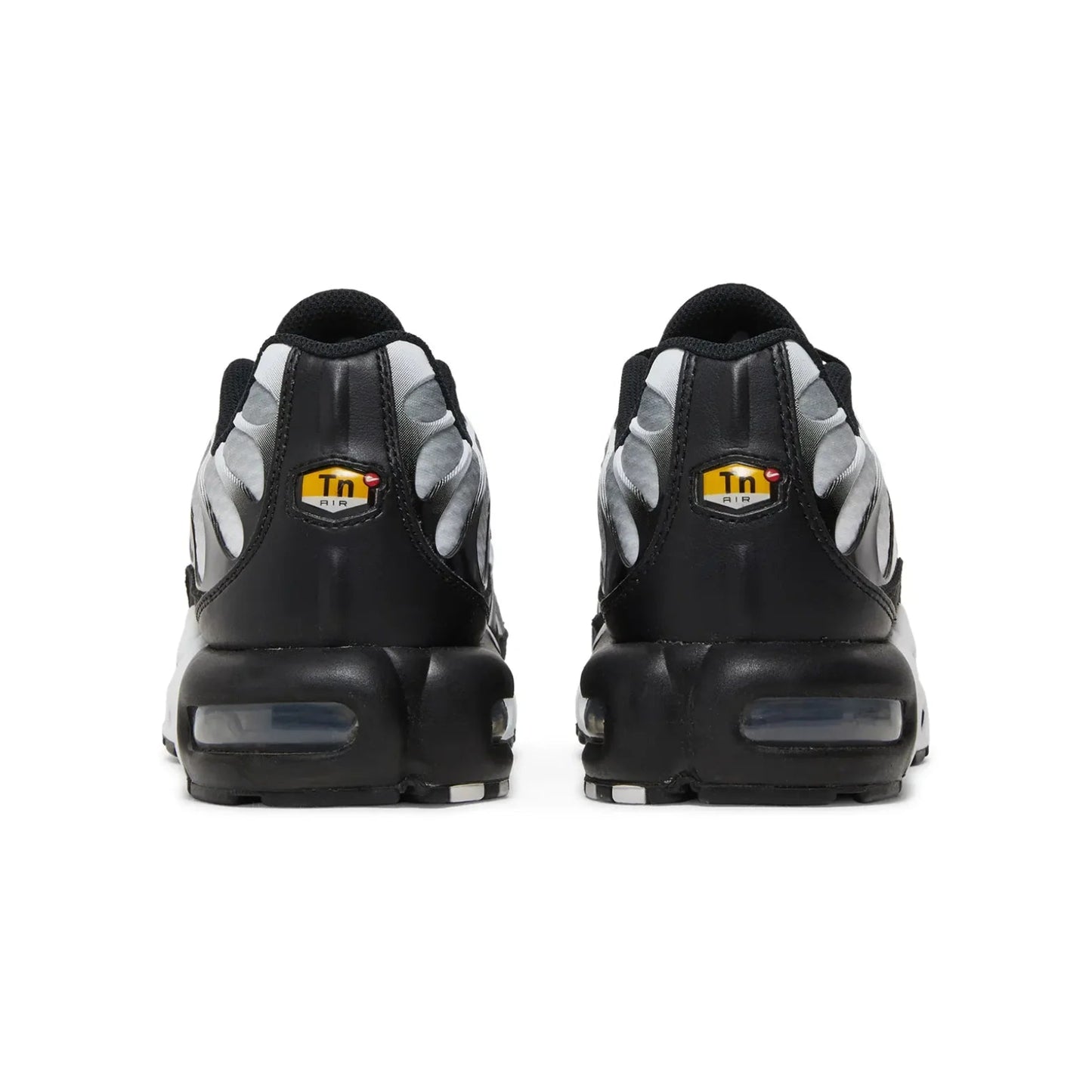 Black and gray sneakers with a yellow logo on a white background