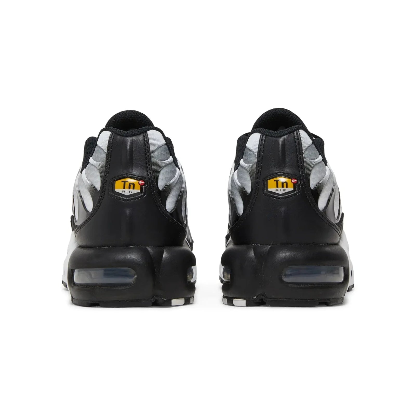 Black and gray sneakers with a yellow logo on a white background
