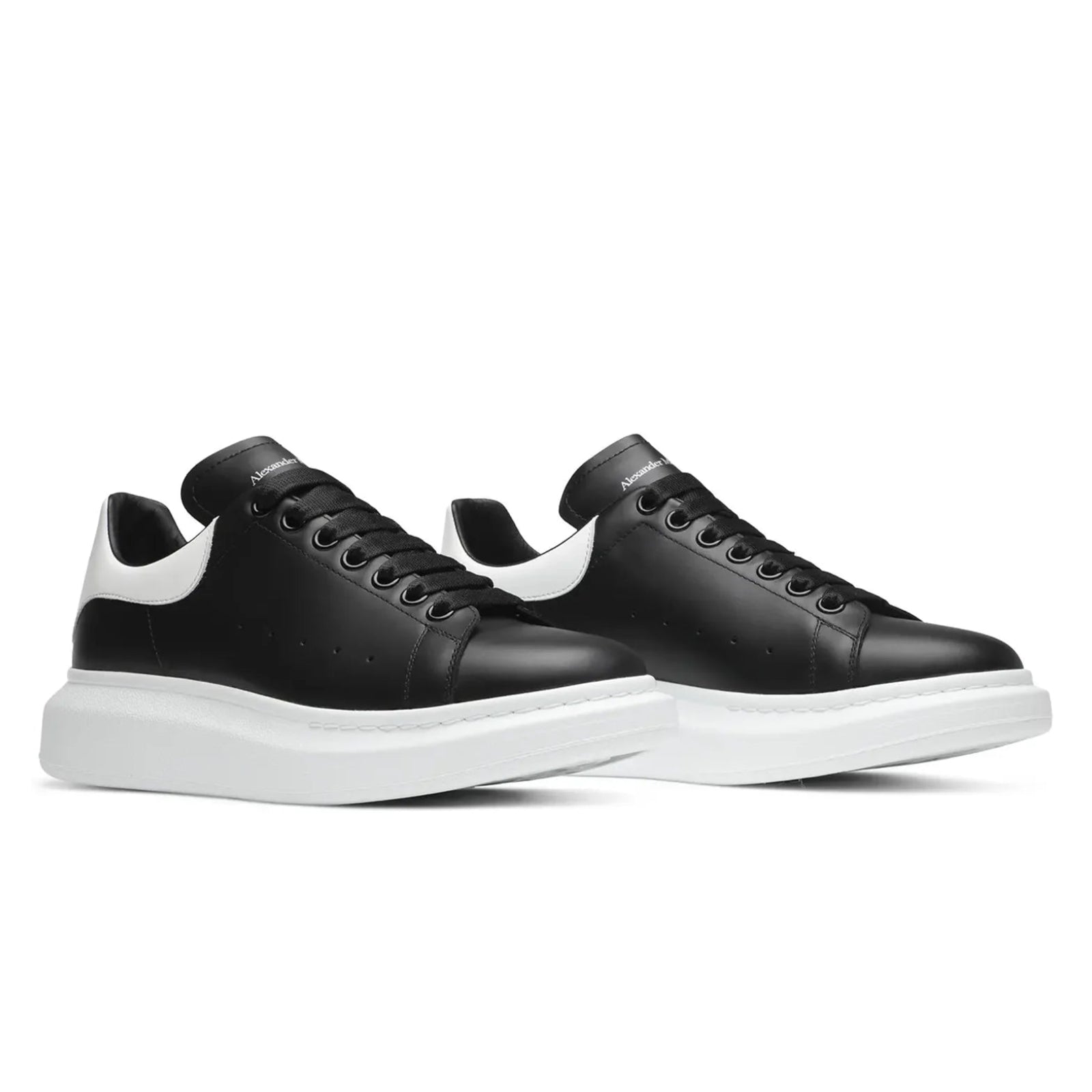 Black sneakers with white soles on a white background
