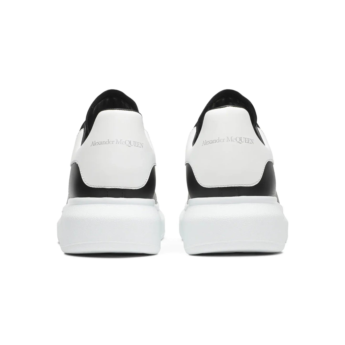 Black and white sneakers with brand logo on a white background