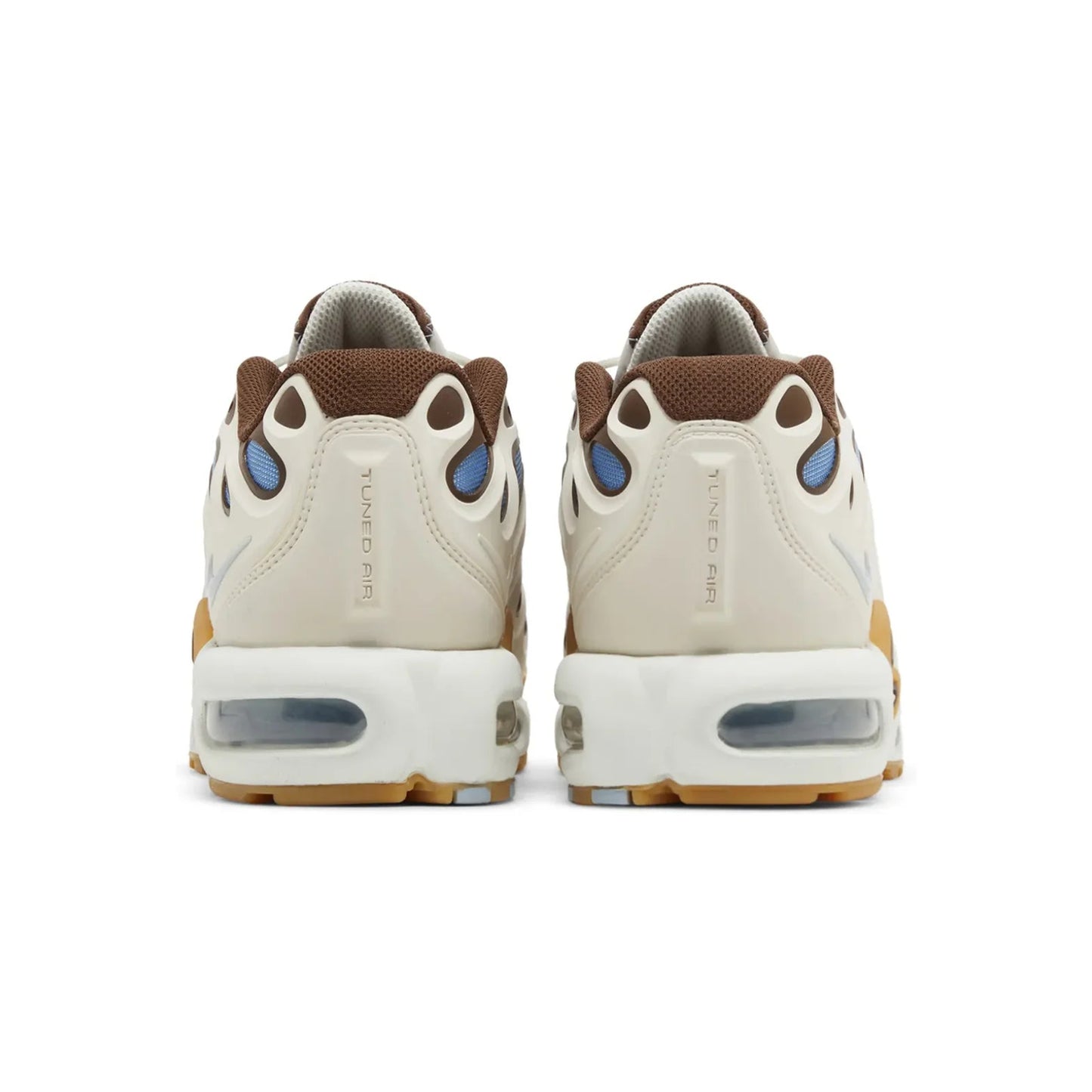 Pair of beige sneakers with brown and blue accents on a white background
