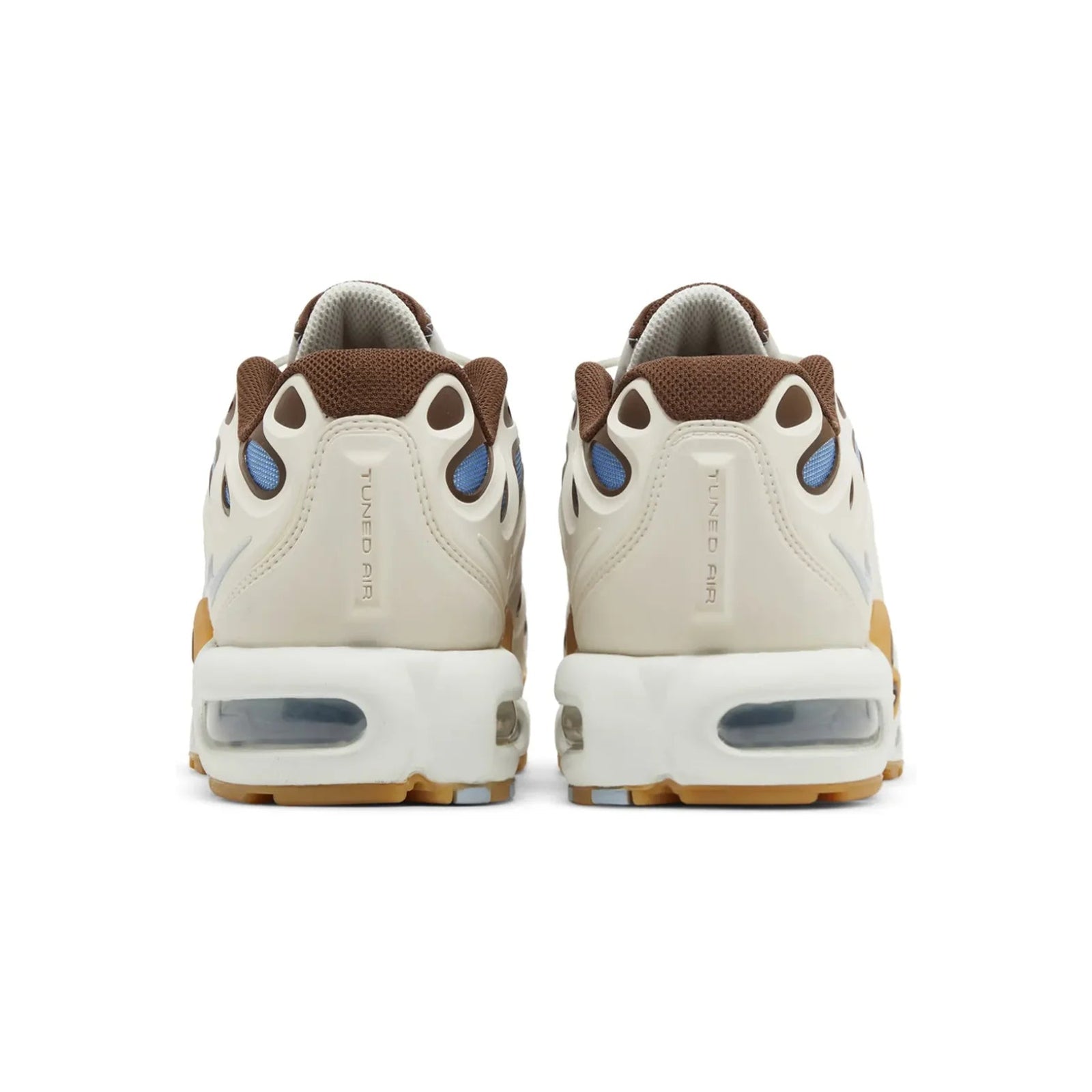 Pair of beige sneakers with brown and blue accents on a white background