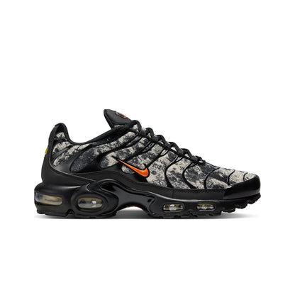 Black and gray sneaker with orange accents on a white background