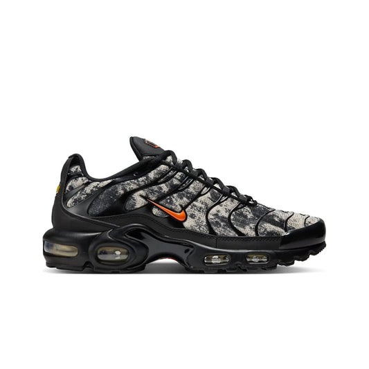 Black and gray sneaker with orange accents on a white background