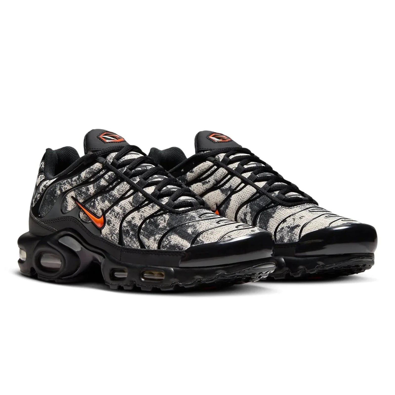 Black and gray sneaker with orange accents on a white background