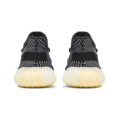 Black sneakers with white soles on a white background