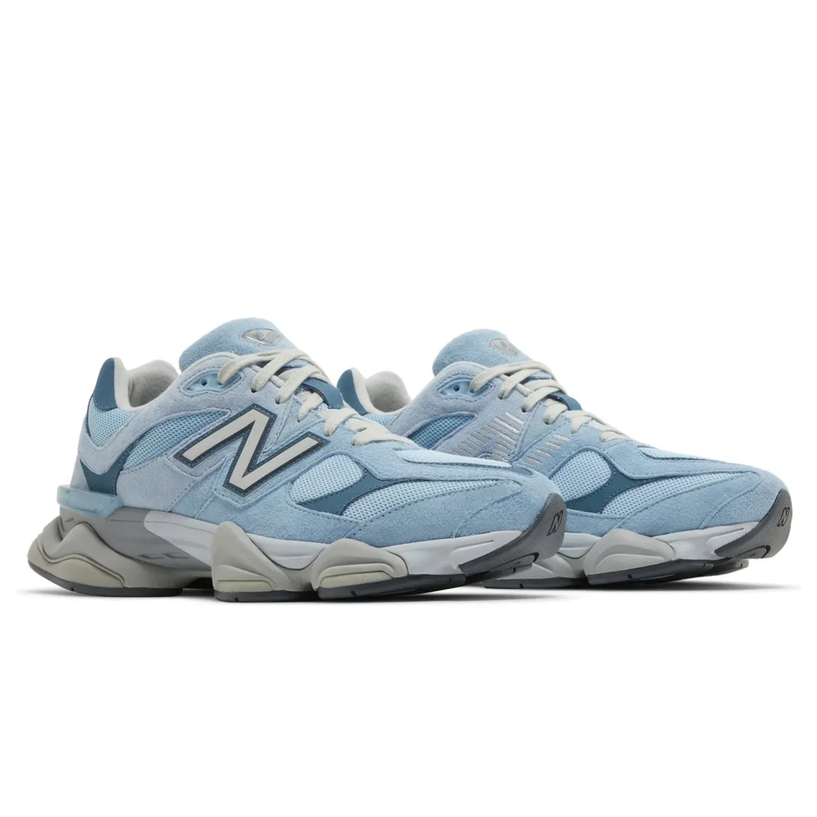 Pair of light blue sneakers with gray soles on a white background