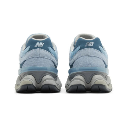 Pair of blue running shoes with a visible brand logo on a white background