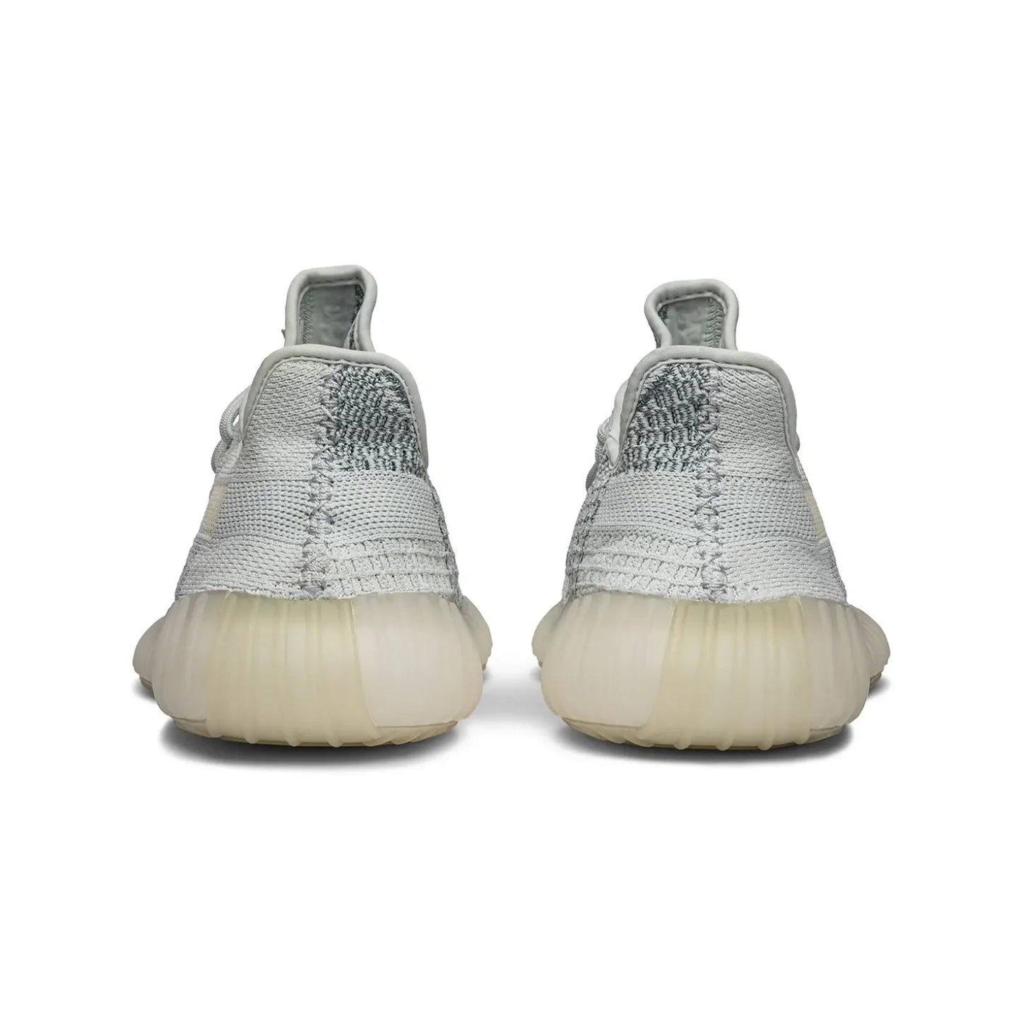 Back view of gray sneakers with white soles on a white background