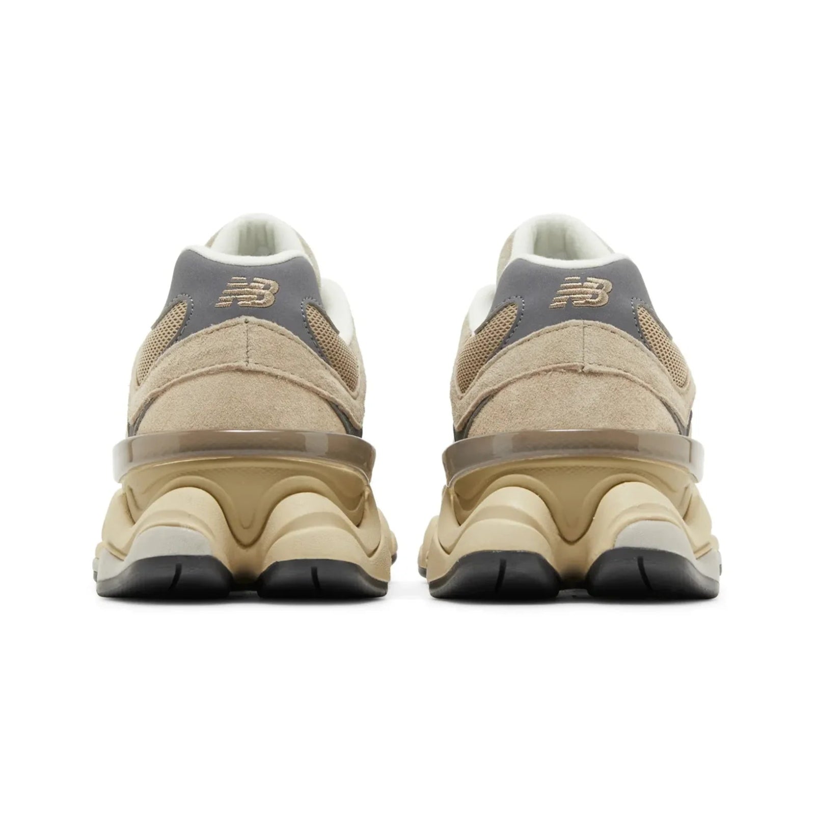 Pair of beige sneakers with black soles on a white background