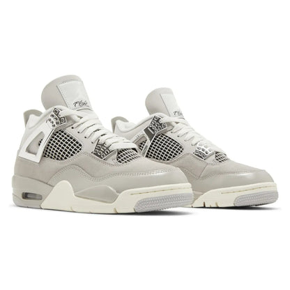 Pair of light gray sneakers with white accents on a white background