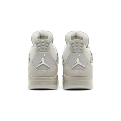 Pair of beige sneakers with a logo on a white background