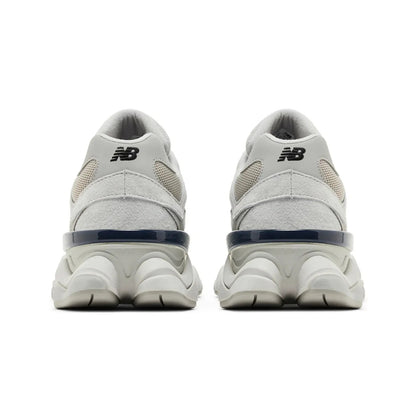 White New Balance sneakers with blue accents on a white background