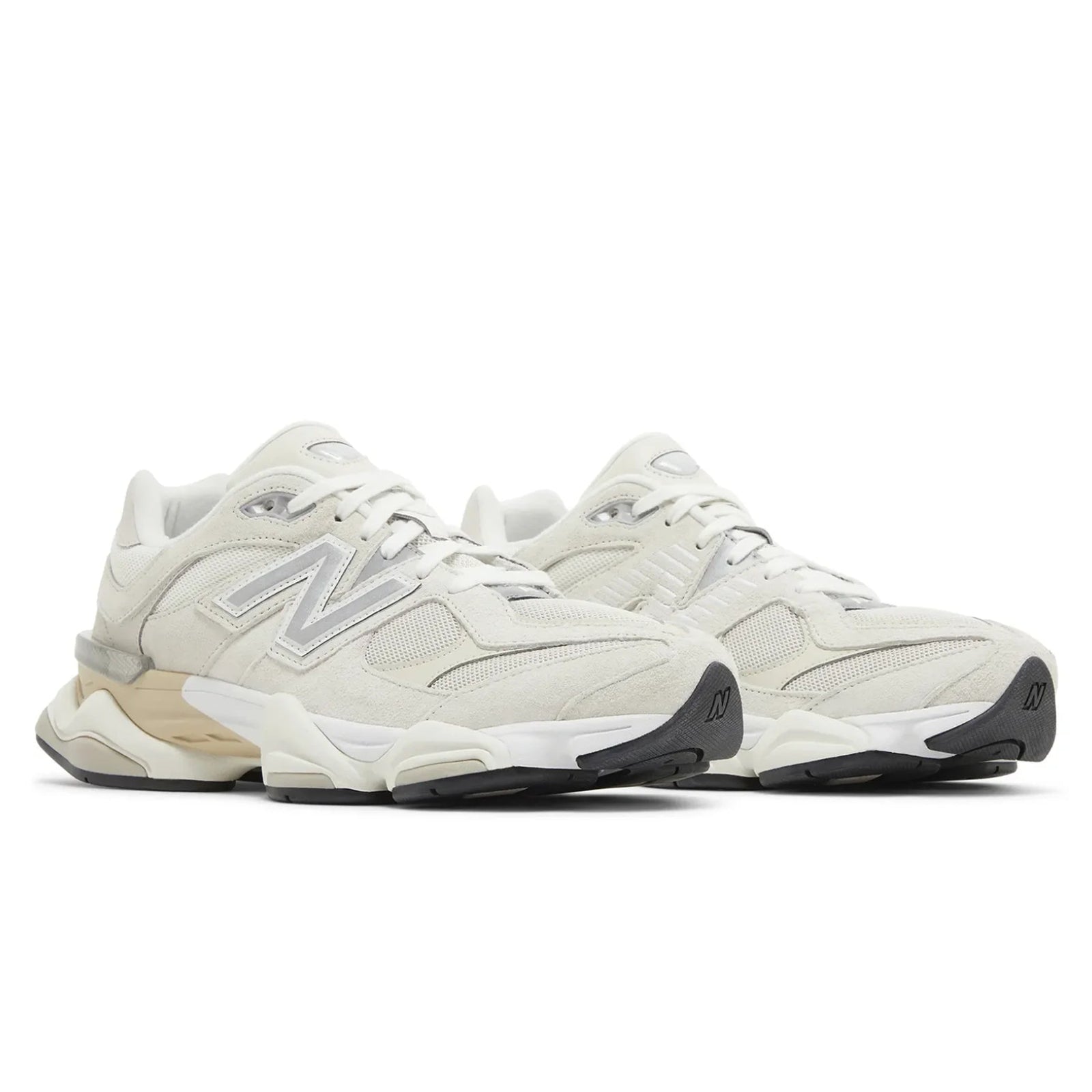 Pair of beige sneakers with New Balance logo on a white background