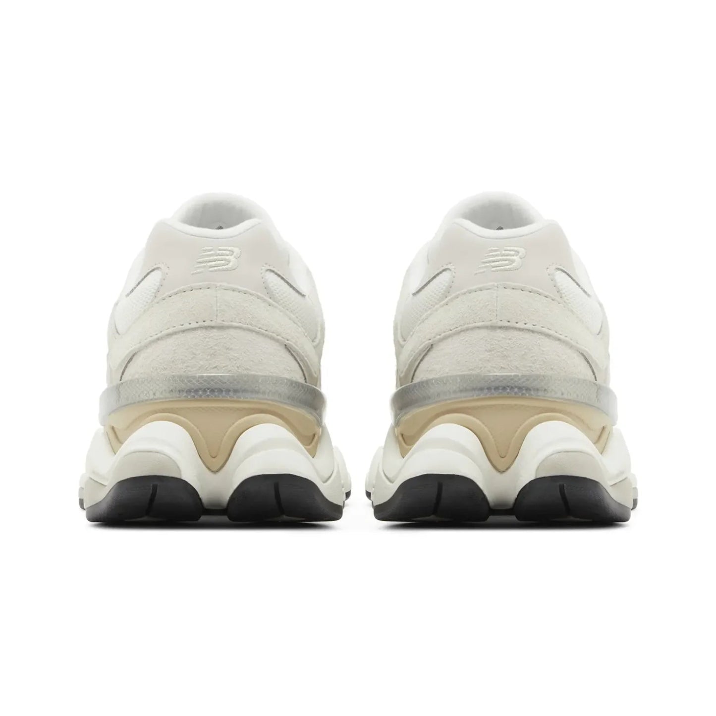 Pair of beige sneakers with black soles on a white background