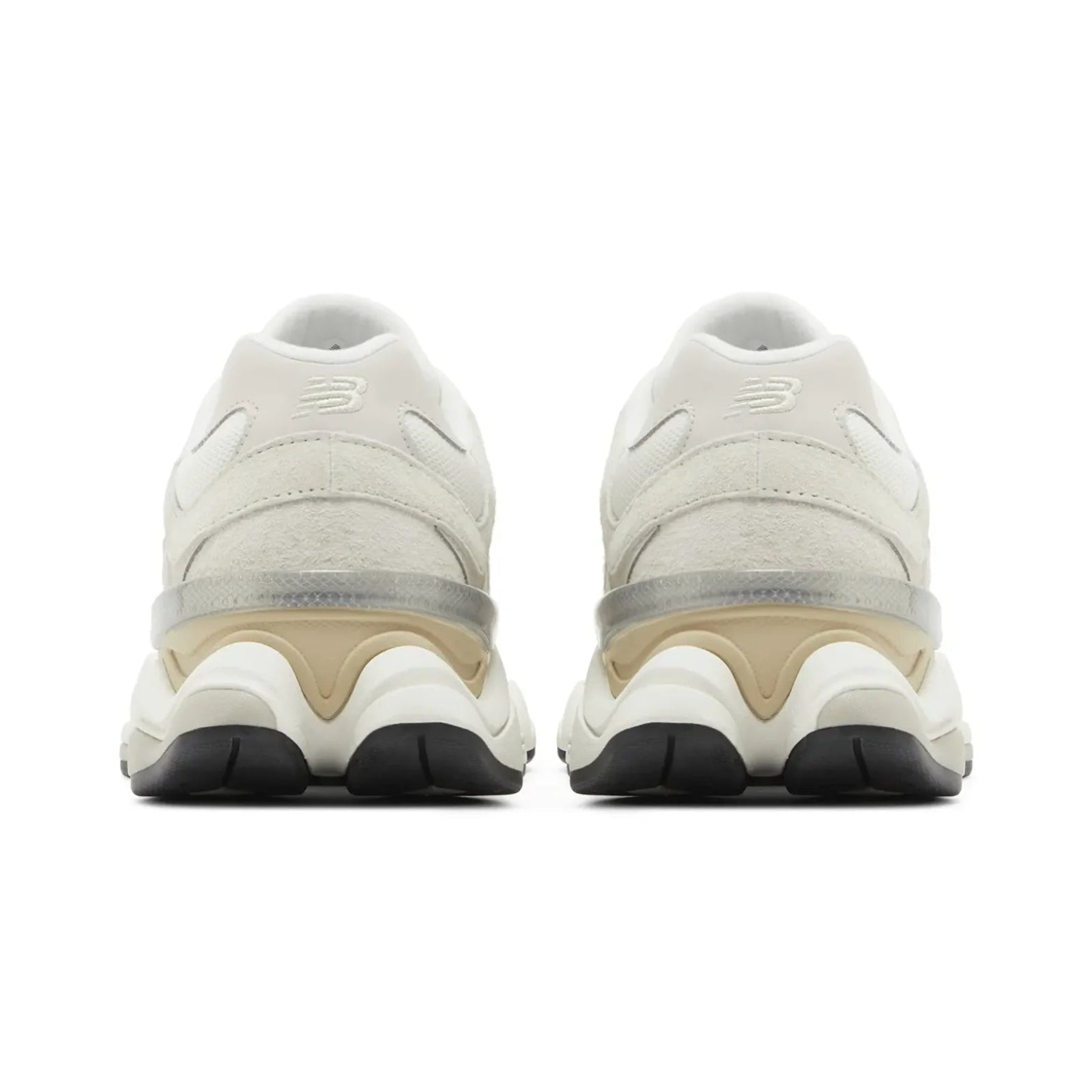 Pair of beige sneakers with black soles on a white background