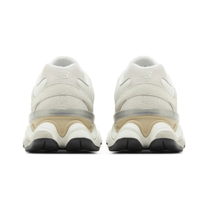Pair of beige sneakers with black soles on a white background