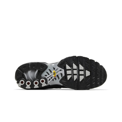 Close-up of a black and gray shoe sole with brand logo on a white background