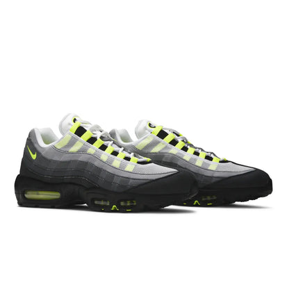 Gray and black sneakers with neon yellow accents on a white background