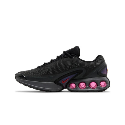 Black sneaker with pink accents on a white background