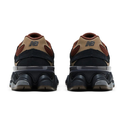 Back view of a pair of brown and black sneakers on a white background