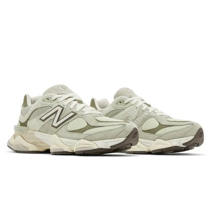 Pair of beige sneakers with New Balance logo on a white background
