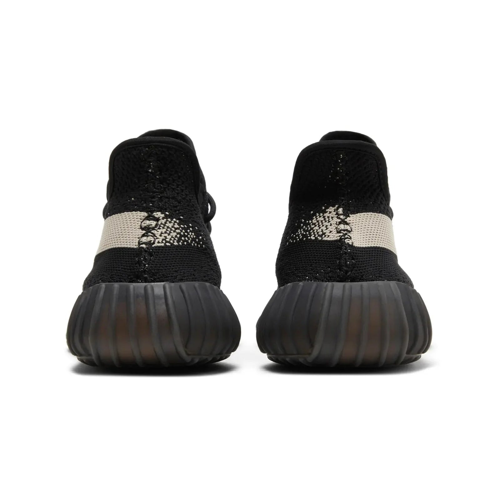 Black and white sneaker with textured sole on a white background