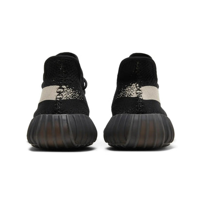 Black and white sneaker with textured sole on a white background