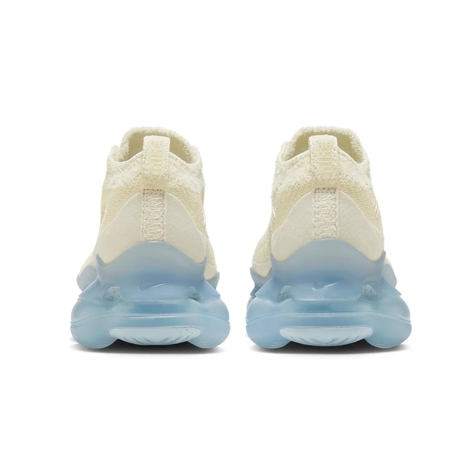Pair of cream-colored sneakers with blue sole on a white background