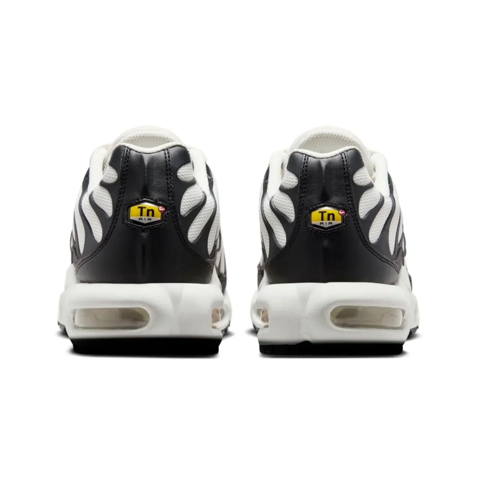 Black and white sneakers with a yellow logo on a white background