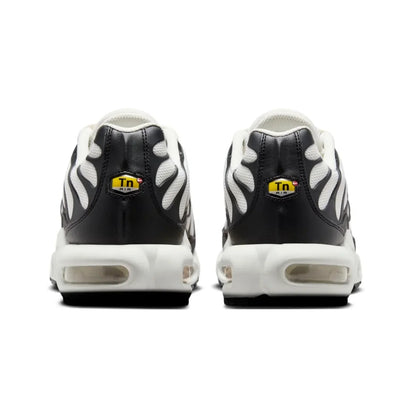 Black and white sneakers with a yellow logo on a white background