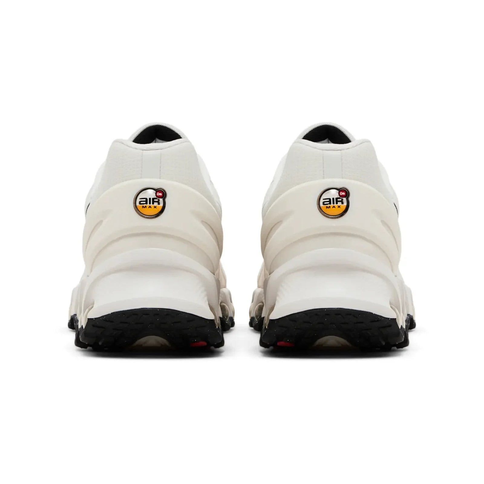 White sneakers with black soles on a white background