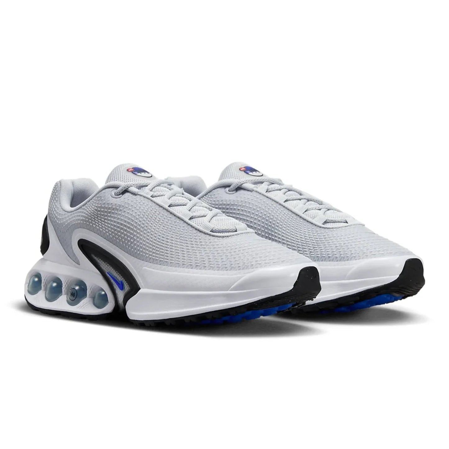 White athletic shoes with blue accents on a white background