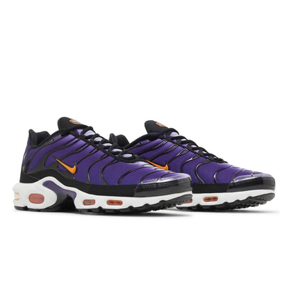 Purple and black sneakers with orange accents on a white background