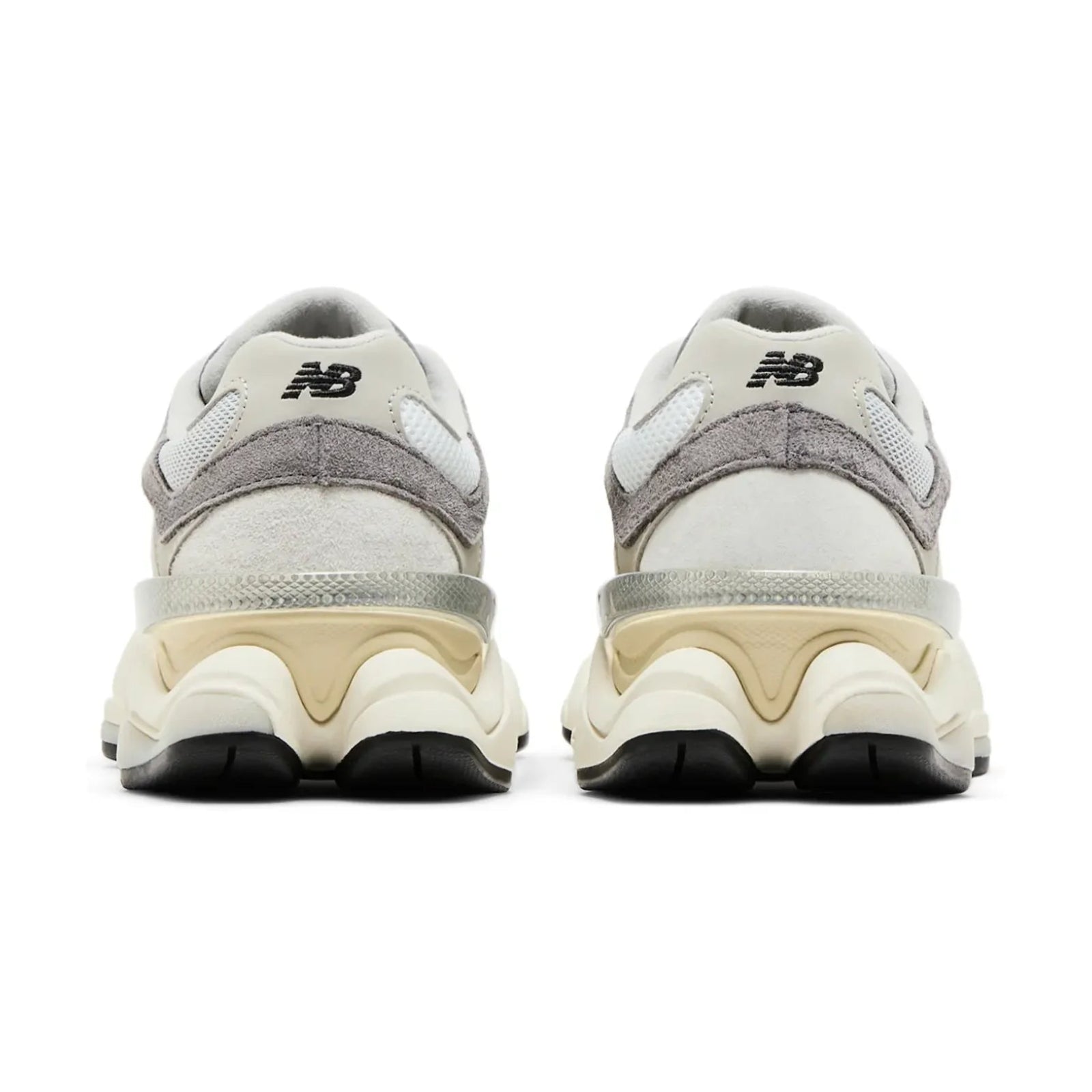 Pair of gray and beige sneakers with New Balance logo on a white background