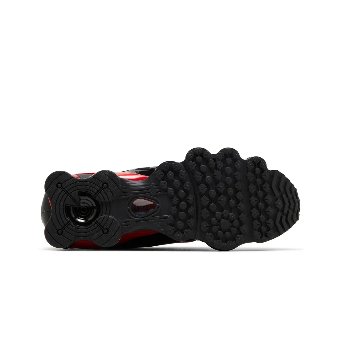 Close-up of a black and red sneaker sole on a white background