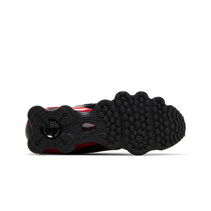 Close-up of a black and red sneaker sole on a white background