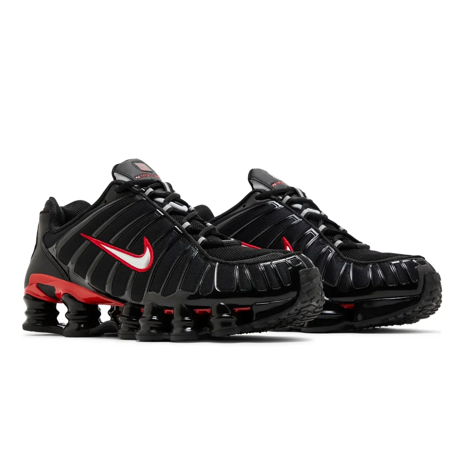 Black and red Nike sneakers on a white background